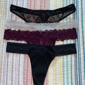 NWOT 4 thong panties from Victoria’s Secret. Sz large, 2 black, 1 plum, 1 beige